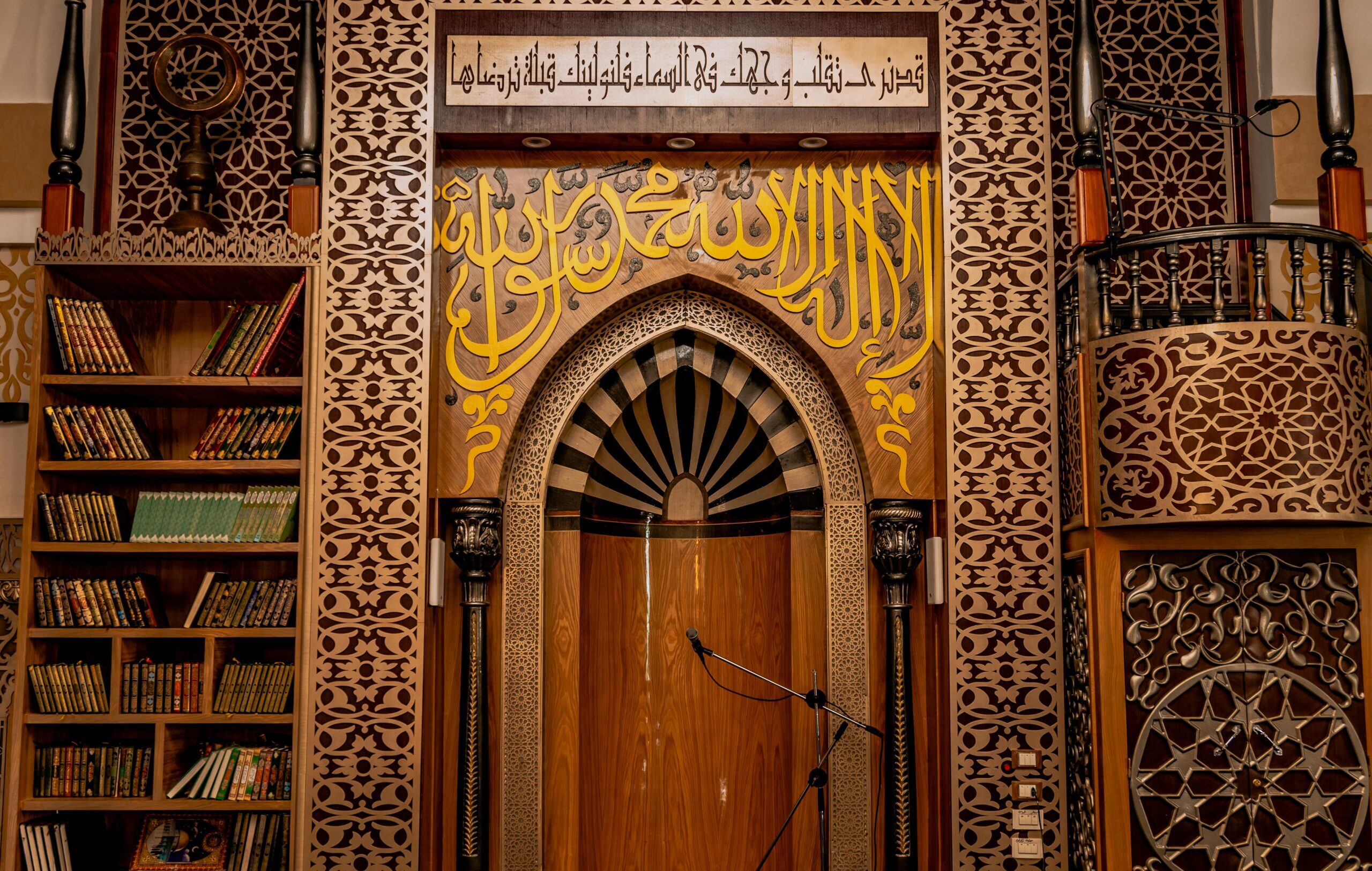 Intricately designed wooden mihrab in an Egyptian mosque with detailed calligraphy.